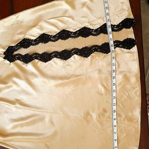 Intimates This gown is gold with black lace on the bust, Size M.